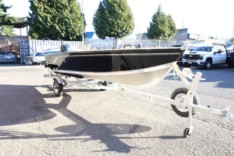 Slide: The Image of 2026 Lund 1600 Fury Tiller boat on trailer in outdoor setting. - 4