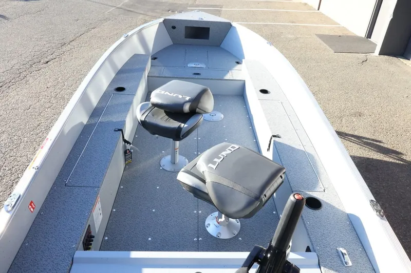 Slide: The Image of 2026 Lund 1600 Fury Tiller boat interior with two swivel seats and spacious deck. - 9
