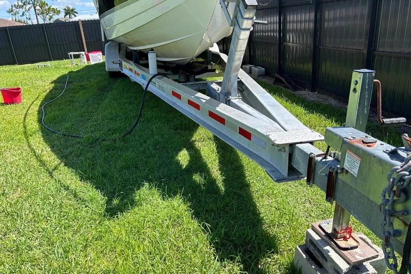 Slide: The Image of 2006 Formula 330 Sun Sport boat on trailer in grassy yard. - 16