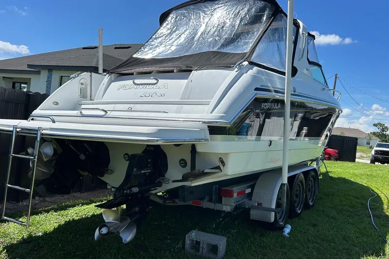 Slide: The Image of 2006 Formula 330 Sun Sport boat on trailer, parked in grassy yard. - 4