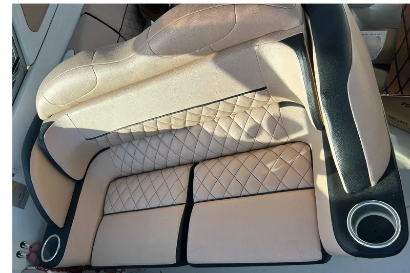Slide: The Image of 2006 Formula 330 Sun Sport boat seating with beige upholstery and cup holders. - 6