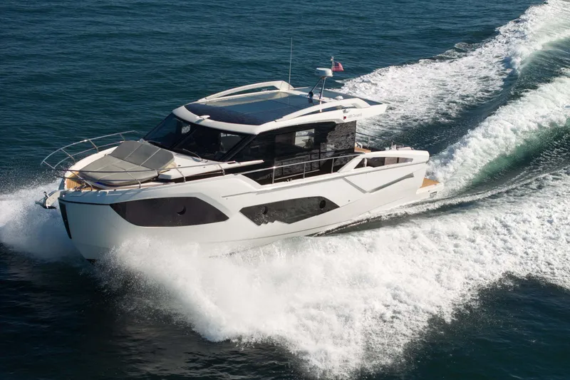 Slide: The Image of 2026 Absolute 48 Coupe yacht cruising on open water, showcasing sleek design and powerful performance. - 1