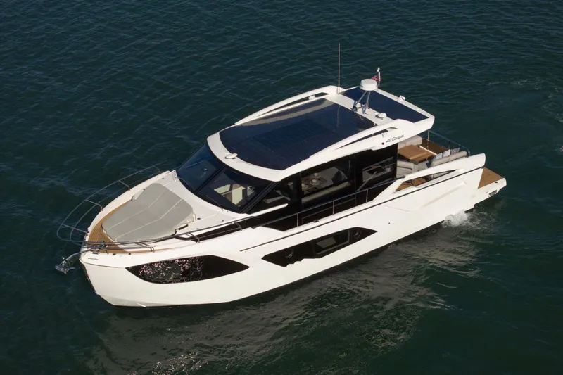 Slide: The Image of 2026 Absolute 48 Coupe yacht cruising on open water, showcasing sleek design and luxury features. - 10