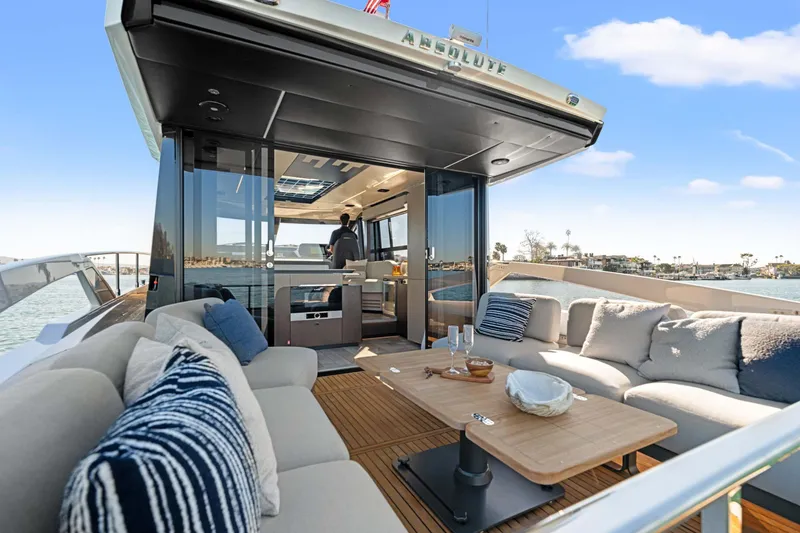 Slide: The Image of Luxurious 2026 Absolute 48 Coupe yacht with elegant outdoor seating and scenic ocean view. - 16
