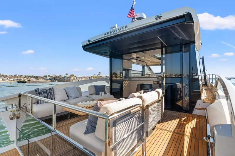 Slide: The Image of Luxurious 2026 Absolute 48 Coupe yacht with elegant outdoor seating and sleek design. - 18