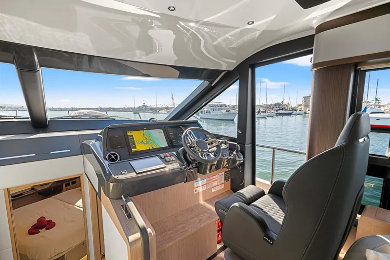 Slide: The Image of Interior of 2026 Absolute 48 Coupe yacht with modern helm and marina view. - 20