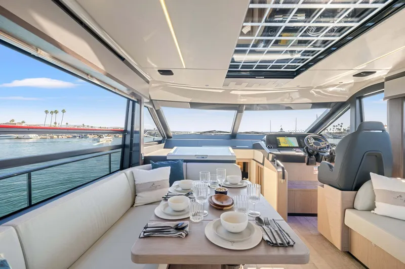 Slide: The Image of Luxurious interior of 2026 Absolute 48 Coupe yacht with elegant dining setup. - 21