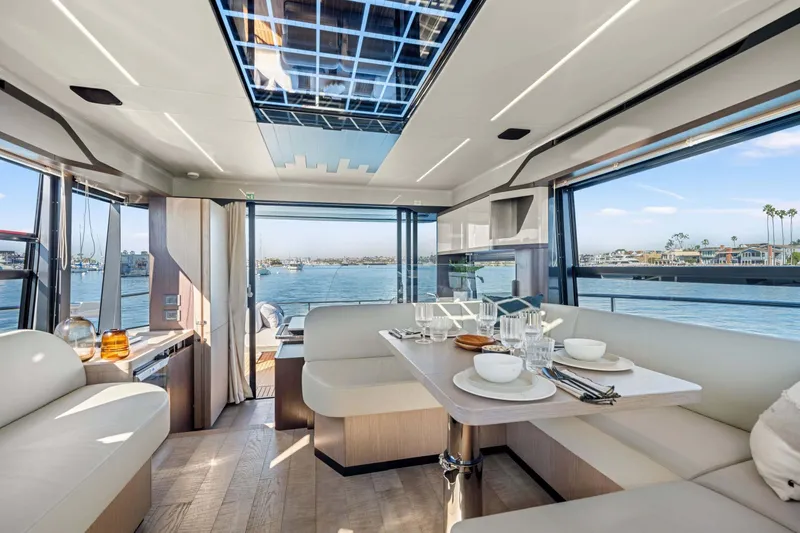Slide: The Image of Luxurious interior of 2026 Absolute 48 Coupe yacht with elegant dining area and scenic ocean view. - 24