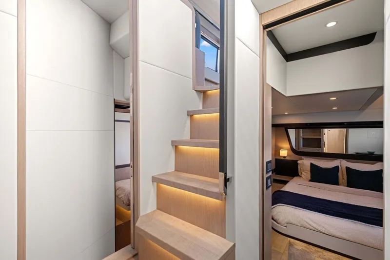 Slide: The Image of Luxurious interior of 2026 Absolute 48 Coupe yacht with modern bedroom and illuminated stairs. - 26