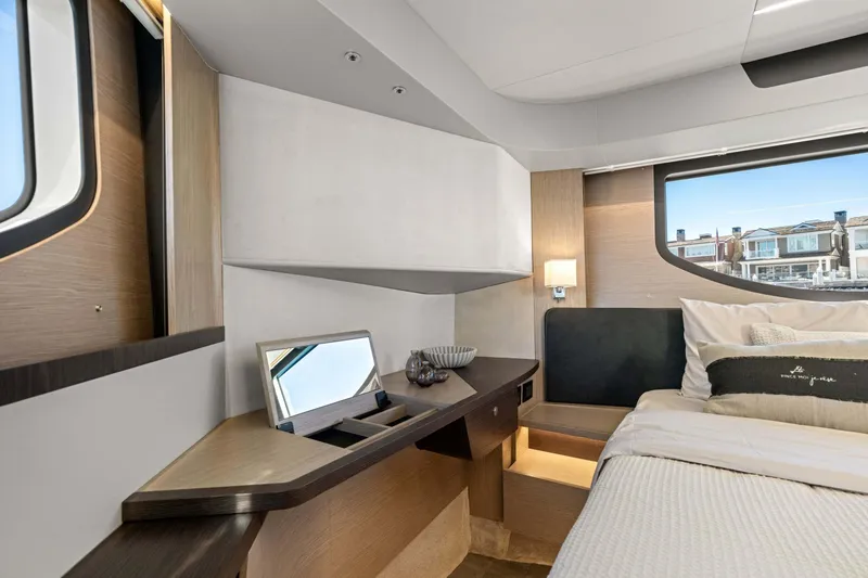 Slide: The Image of Luxurious interior of 2026 Absolute 48 Coupe yacht bedroom with modern design and large windows. - 30