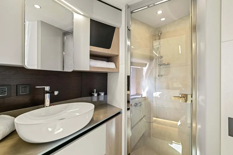 Slide: The Image of Luxurious bathroom in 2026 Absolute 48 Coupe yacht with modern fixtures and elegant design. - 31