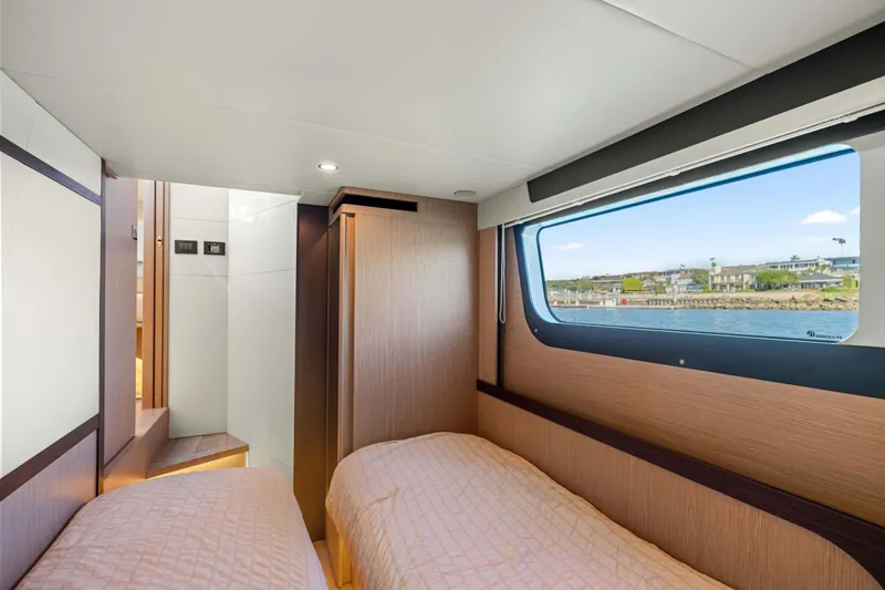 Slide: The Image of Luxurious cabin interior of 2026 Absolute 48 Coupe yacht with scenic window view. - 34