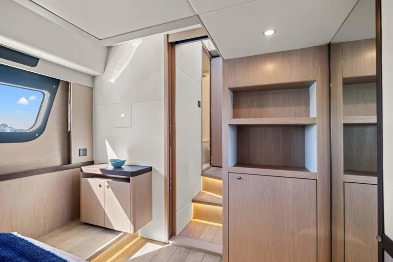 Slide: The Image of Luxurious interior of 2026 Absolute 48 Coupe yacht with modern wood cabinetry. - 40