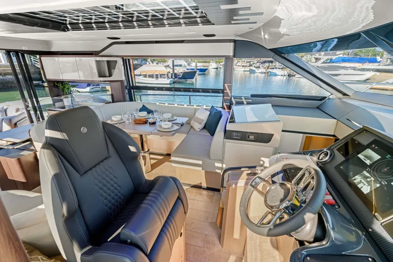 Slide: The Image of Luxurious interior of 2026 Absolute 48 Coupe yacht with modern helm and dining area. - 43