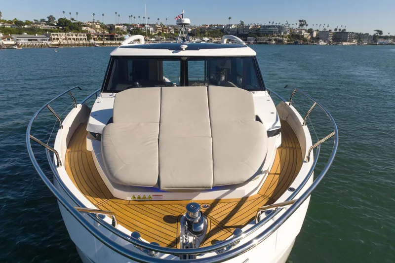 Slide: The Image of 2026 Absolute 48 Coupe yacht with sun deck, cruising on calm waters. - 6