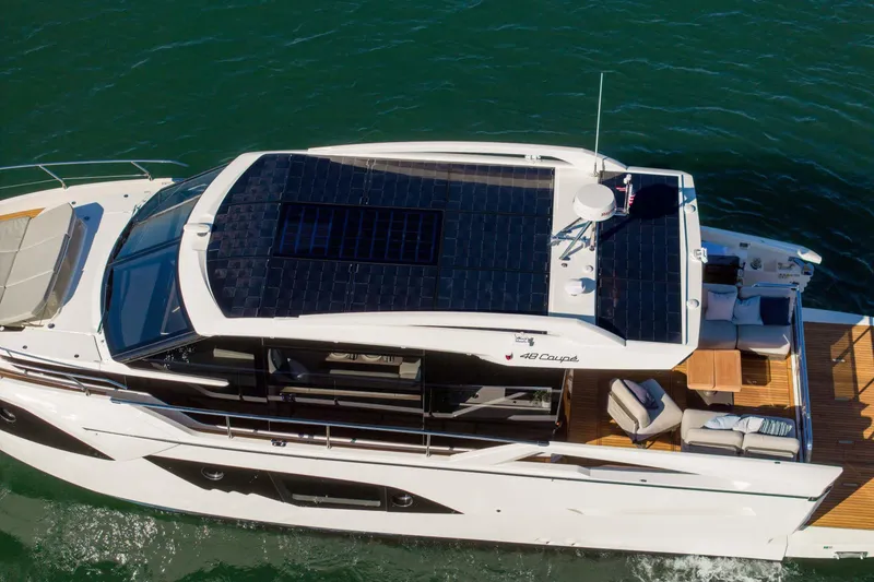 Slide: The Image of 2026 Absolute 48 Coupe yacht with solar panels cruising on water. - 8
