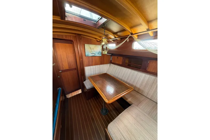 Slide: The Image of Interior of 1978 Vindo 50 sailboat with wooden table and seating area. - 11