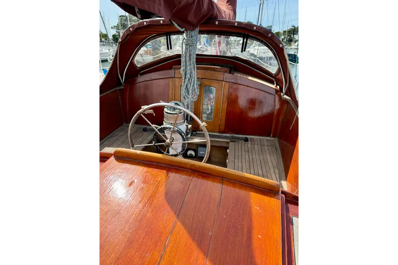 Slide: The Image of 1978 Vindo 50 sailboat cockpit with wooden finish and steering wheel. - 18