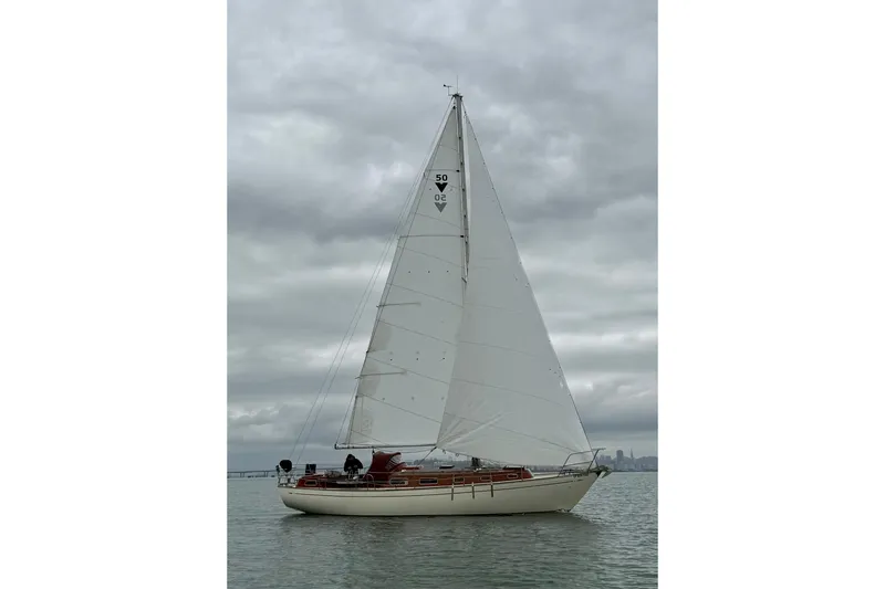 Slide: The Image of Vintage 1978 Vindo 50 sailboat on calm waters under cloudy skies. - 20