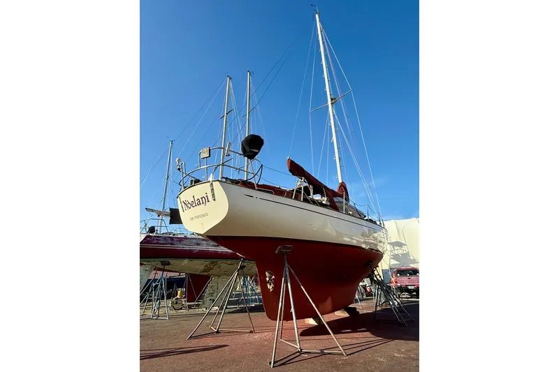 Slide: The Image of 1978 Vindo 50 sailboat on dry dock under clear blue sky. - 5