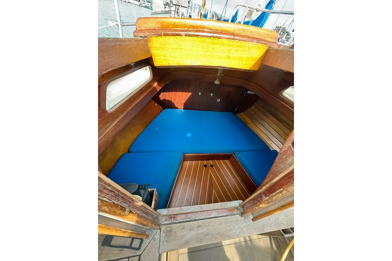 Slide: The Image of Interior cabin of 1978 Vindo 50 sailboat with blue cushions and wooden finish. - 7