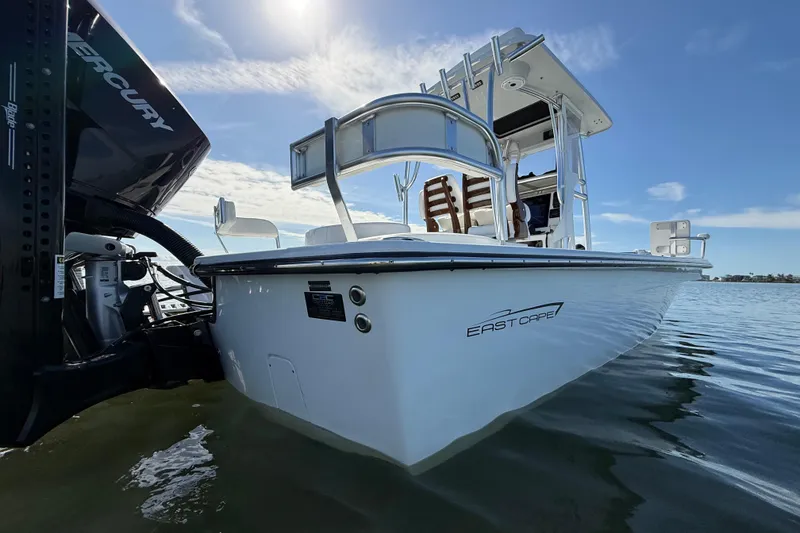 Slide: The Image of 2024 East Cape 25 Hybrid boat on water, featuring sleek design and Mercury engine. - 13