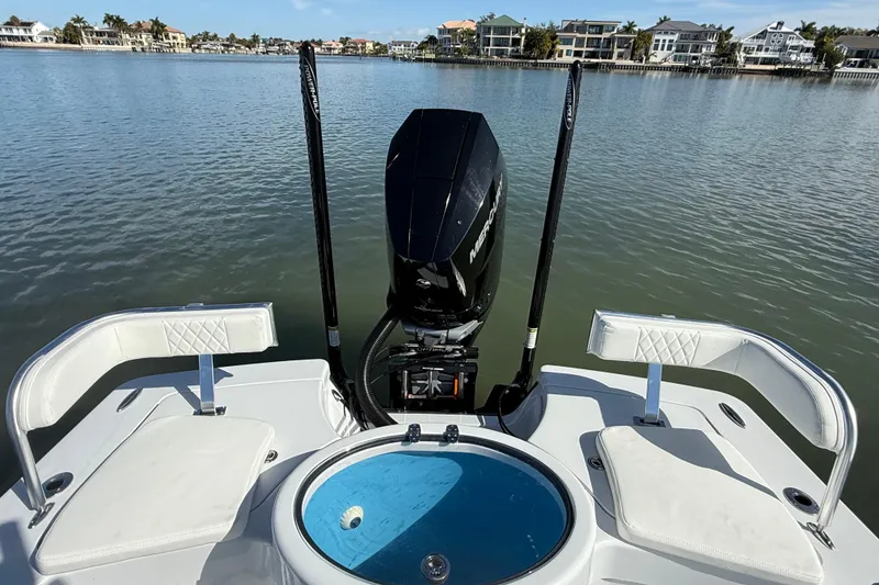 Slide: The Image of 2024 East Cape 25 Hybrid boat with Mercury engine on calm water. - 14