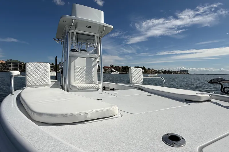 Slide: The Image of 2024 East Cape 25 Hybrid boat on water, featuring sleek white design and comfortable seating. - 36