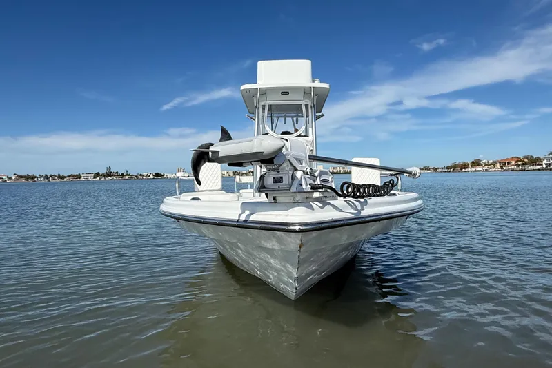 Slide: The Image of 2024 East Cape 25 Hybrid boat on calm water under clear blue sky. - 4