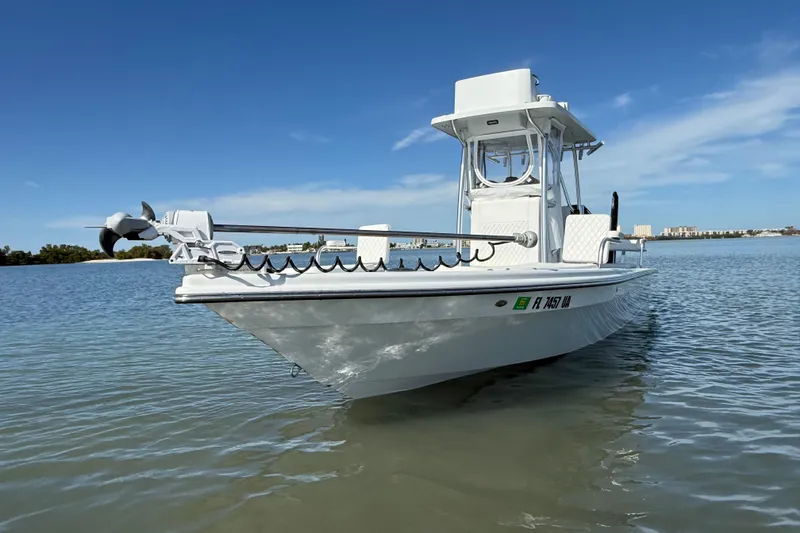 Slide: The Image of 2024 East Cape 25 Hybrid boat on calm water under clear blue sky. - 6