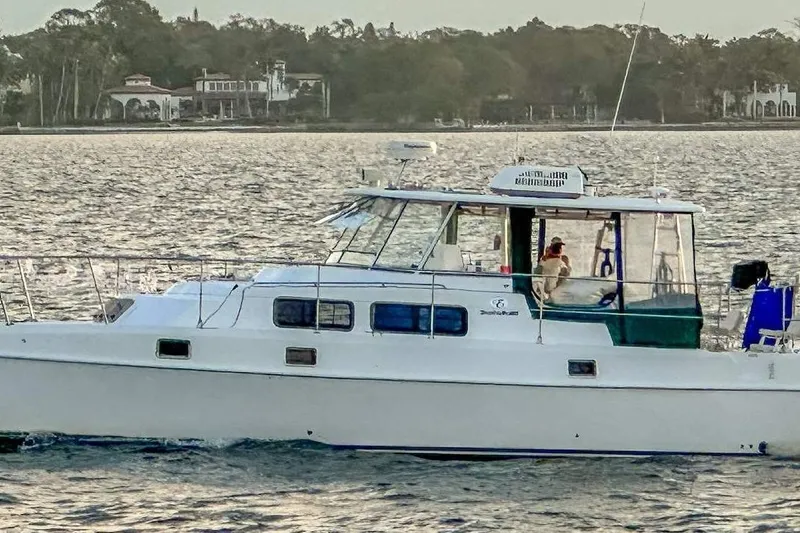 The Image of 2003 Endeavour 36 TrawlerCat cruising on a scenic waterway. - 1