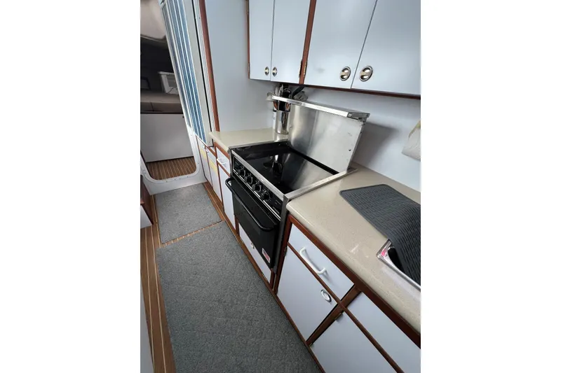 Slide: The Image of 2003 Endeavour 36 TrawlerCat kitchen with stove, cabinets, and countertop. - 10