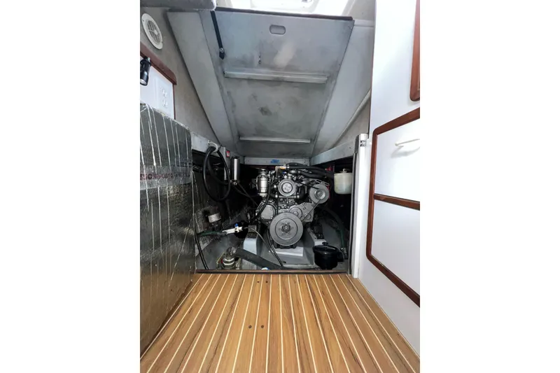 Slide: The Image of Engine room of 2003 Endeavour 36 TrawlerCat with visible machinery and wooden flooring. - 17