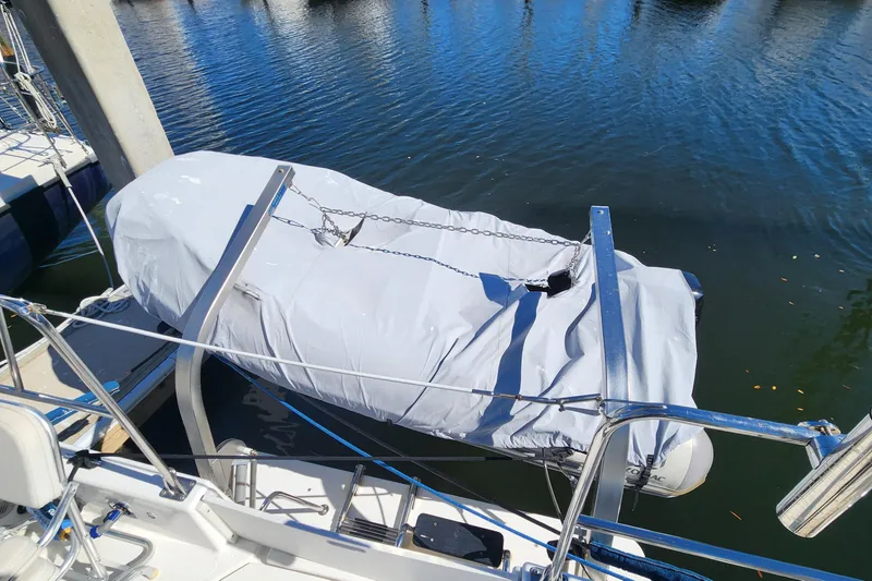 Slide: The Image of Covered dinghy on Endeavour 36 TrawlerCat, 2003, docked on calm water. - 20