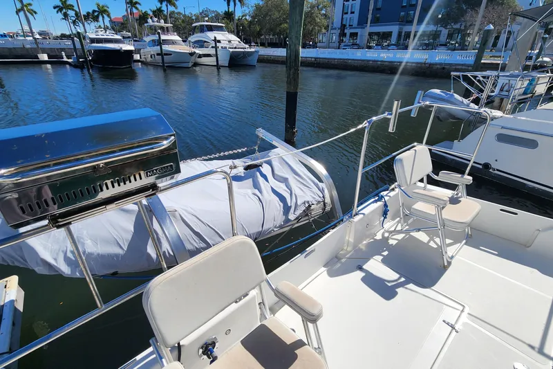 Slide: The Image of 2003 Endeavour 36 TrawlerCat with deck chairs and grill, docked at marina. - 21