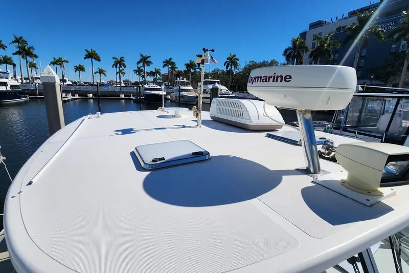 Slide: The Image of 2003 Endeavour 36 TrawlerCat docked, featuring Raymarine equipment under clear blue skies. - 23