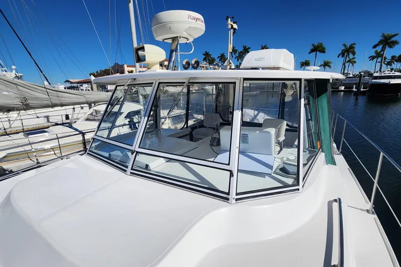 Slide: The Image of 2003 Endeavour 36 TrawlerCat at marina, featuring spacious cockpit and modern navigation equipment. - 24