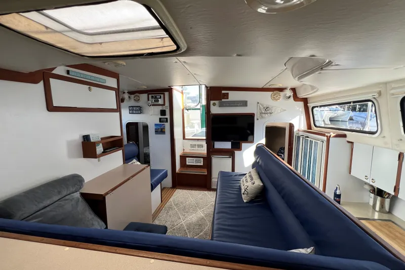 Slide: The Image of Interior of 2003 Endeavour 36 TrawlerCat with cozy seating and nautical decor. - 3
