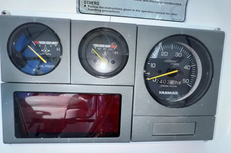 Slide: The Image of Dashboard gauges of a 2003 Endeavour 36 TrawlerCat, showing oil pressure and engine hours. - 30