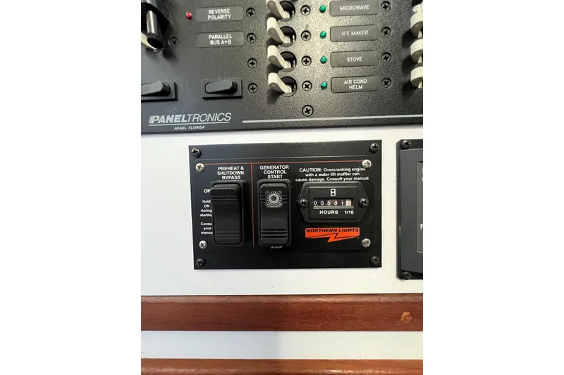 Slide: The Image of Control panel of a 2003 Endeavour 36 TrawlerCat, featuring generator and electrical switches. - 32