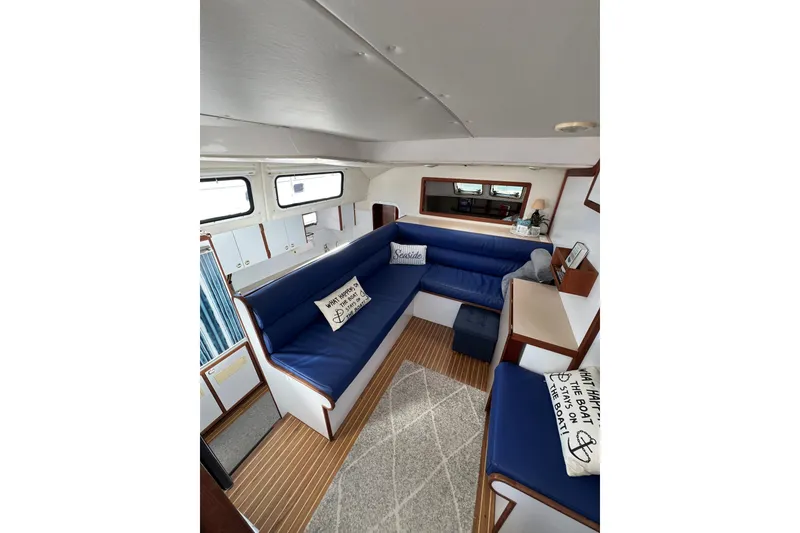 Slide: The Image of Interior of 2003 Endeavour 36 TrawlerCat with blue seating and nautical decor. - 4