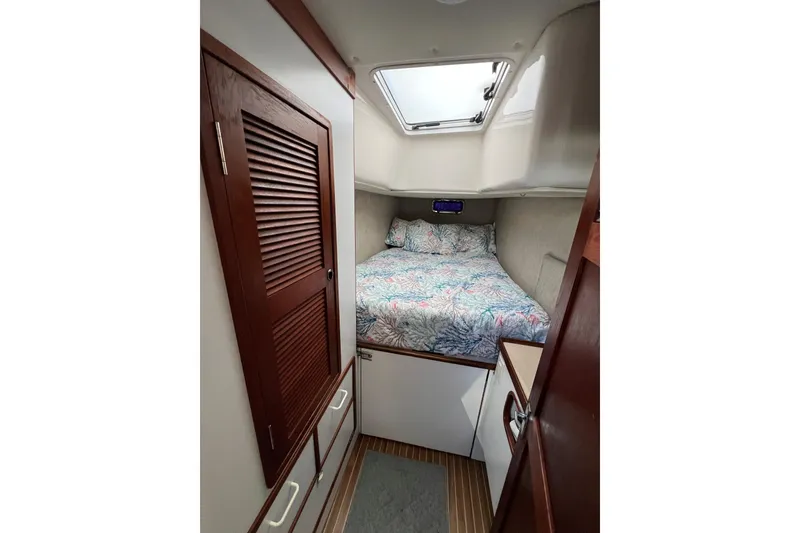 Slide: The Image of Cozy cabin interior of 2003 Endeavour 36 TrawlerCat with bed and wooden cabinetry. - 7