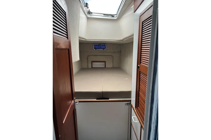 Slide: The Image of Cabin interior of 2003 Endeavour 36 TrawlerCat with bed and wooden doors. - 9
