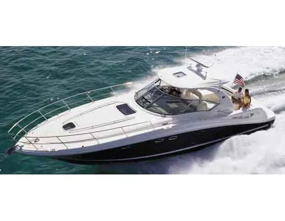 Slide: The Image of 2004 Sea Ray 420 Sundancer docked in a marina, showcasing sleek design and spacious deck. - 1
