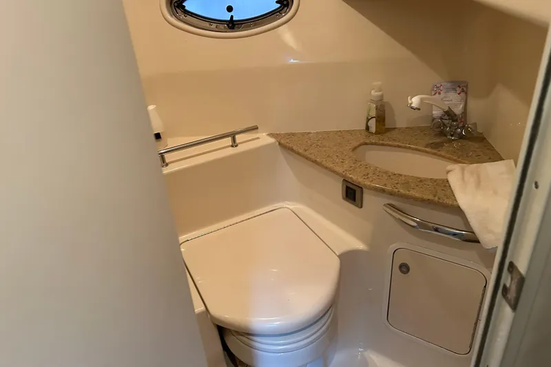 Slide: The Image of 2004 Sea Ray 420 Sundancer bathroom with granite countertop and compact design. - 12