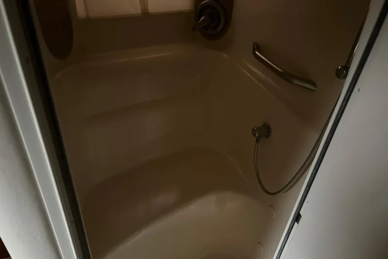 Slide: The Image of Shower area inside 2004 Sea Ray 420 Sundancer yacht, featuring a handheld showerhead. - 16