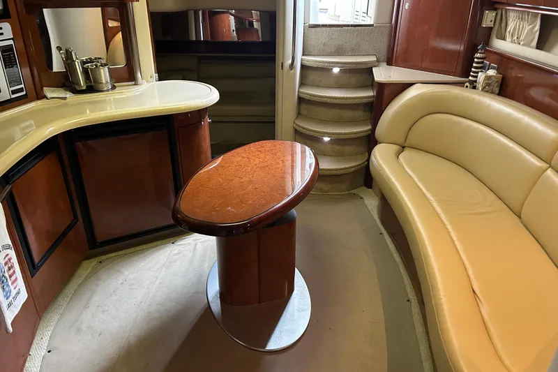 Slide: The Image of Luxurious interior of 2004 Sea Ray 420 Sundancer yacht with elegant seating and table. - 17