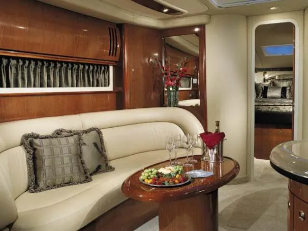 Slide: The Image of 2004 Sea Ray 420 Sundancer docked in a marina, sheltered by a metal structure. - 2