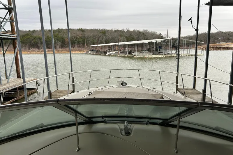 Slide: The Image of 2004 Sea Ray 420 Sundancer docked at a marina with wooded shoreline. - 6