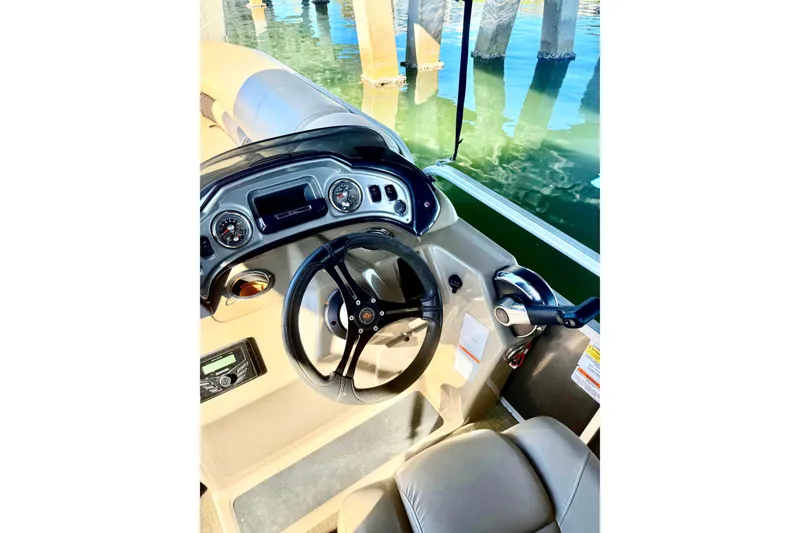 Slide: The Image of 2023 Sun Tracker Party Barge 22 DLX helm with steering wheel and controls. - 2